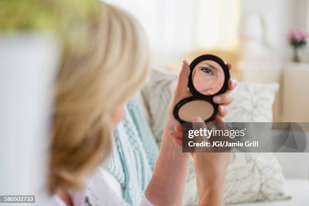 caucasian woman admiring herself in mirror - compact stock pictures, royalty-free photos & images