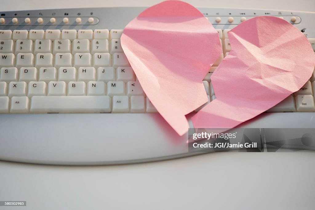 Close up of broken heart on computer keyboard