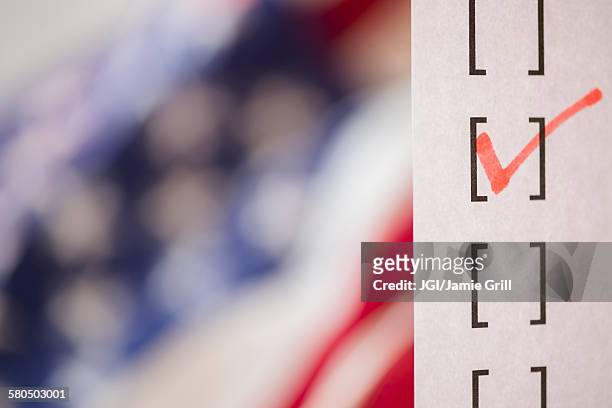 close up of voting ballot near american flag - voting ストックフォトと画像