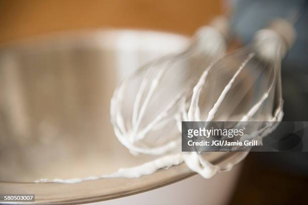 close up of electric mixer whipping cream - ballonklopper stockfoto's en -beelden