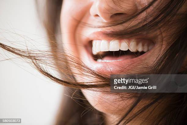 close up of laughing woman with messy hair - toothy smile stock pictures, royalty-free photos & images