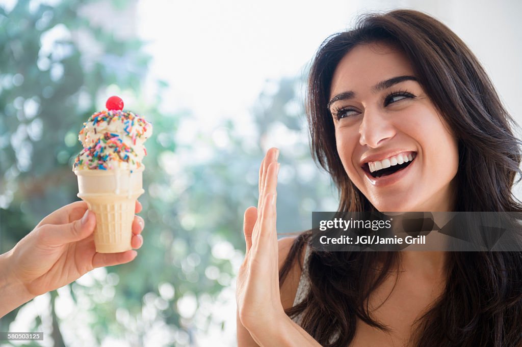 Woman refusing ice cream cone