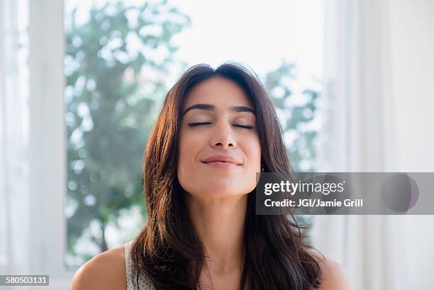 calm woman breathing with eyes closed - durchatmen stock-fotos und bilder