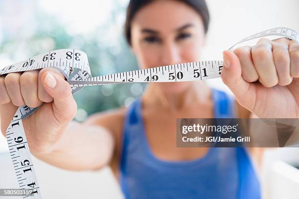 woman holding measuring tape - woman waist up stock pictures, royalty-free photos & images