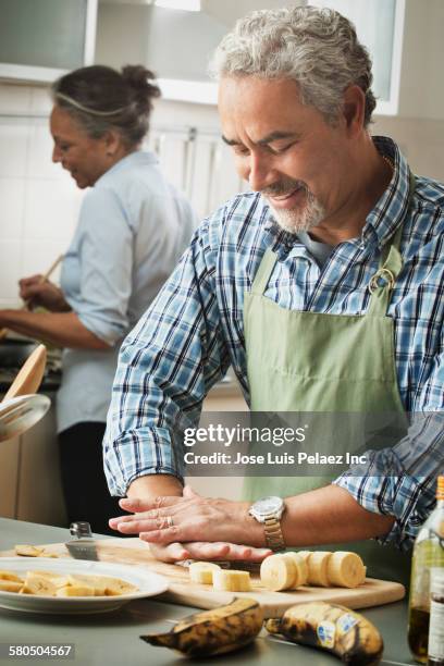 hispanic couple cooking in kitchen - plantain stock pictures, royalty-free photos & images