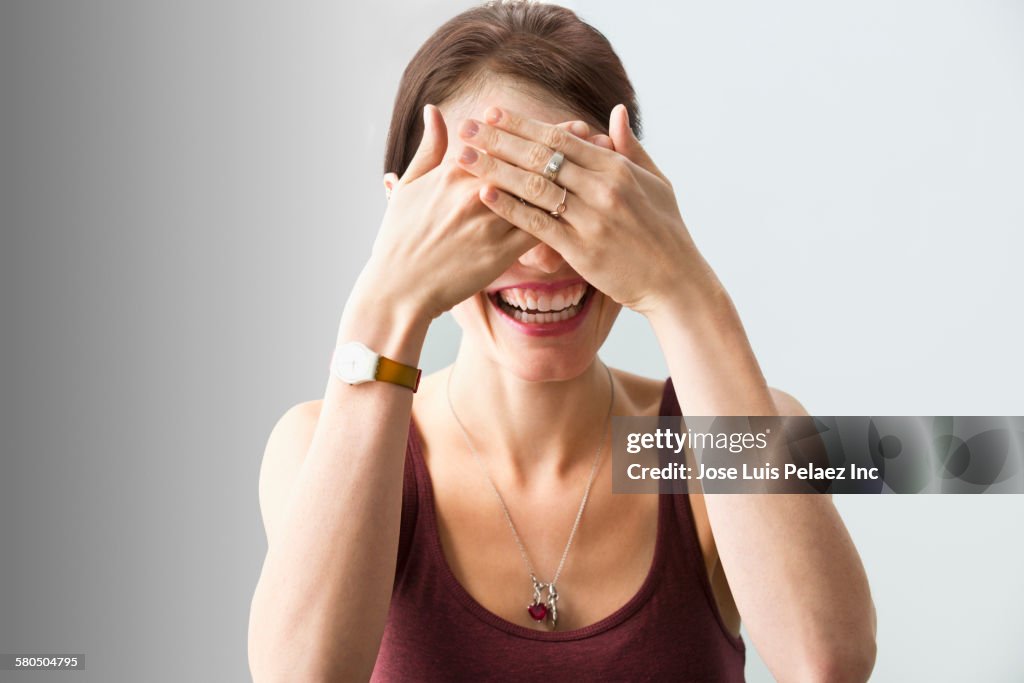 Caucasian woman covering her eyes