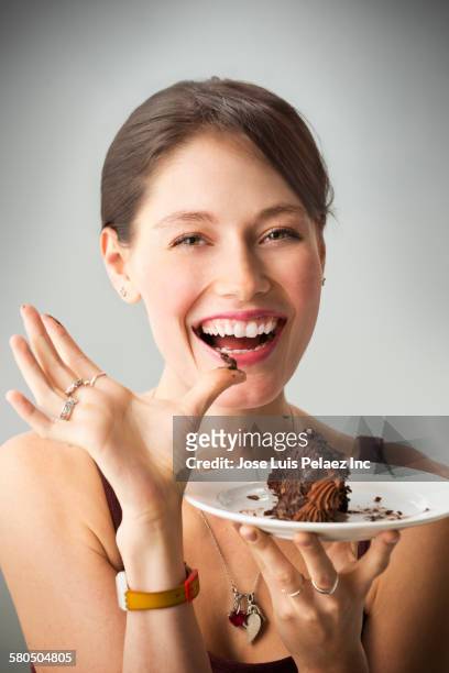 caucasian woman eating chocolate cake - women licking women stock-fotos und bilder
