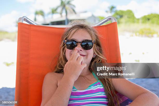 caucasian girl picking nose on beach - picking her nose stock pictures, royalty-free photos & images