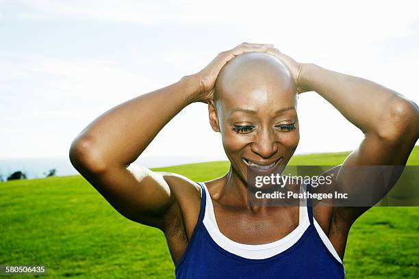 african american woman smiling in park - hair loss in woman stock pictures, royalty-free photos & images