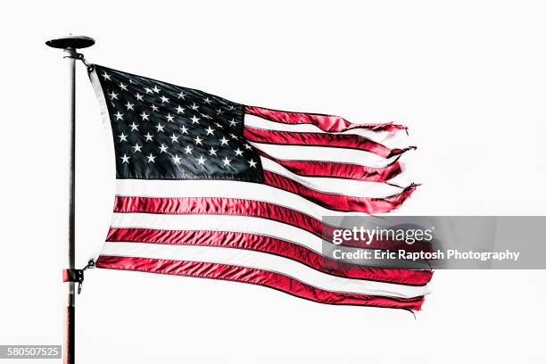 tattered american flag flying from flagpole - torn flag stock pictures, royalty-free photos & images