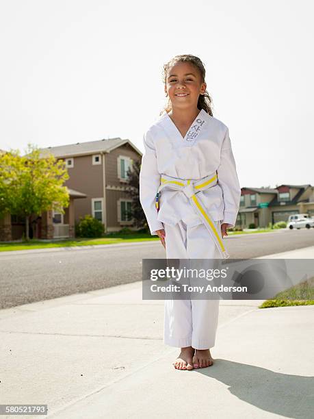 girl in karate gi on neighborhood street - gidräkt bildbanksfoton och bilder