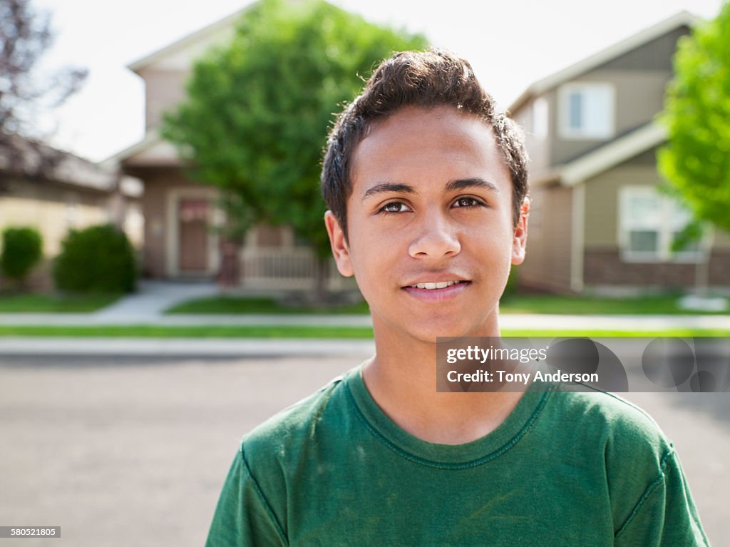 Portrait of a teenaged boy on neighborhood street