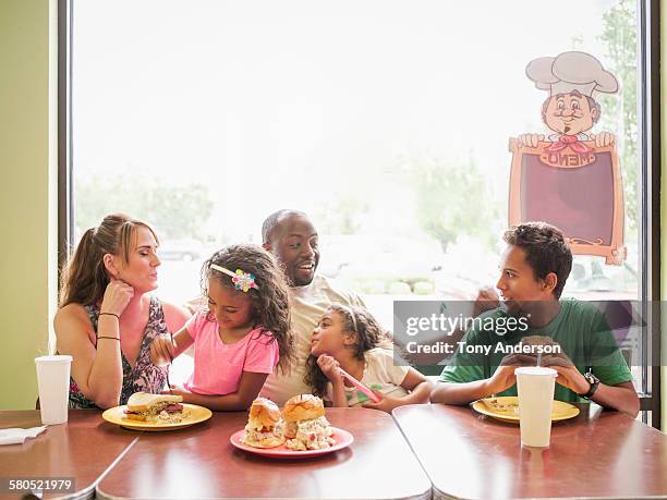 family dining in fast food restaurant - fastfood restaurant table stock-fotos und bilder