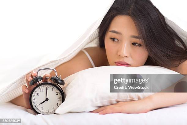 young woman getting up - hitting alarm clock stock pictures, royalty-free photos & images