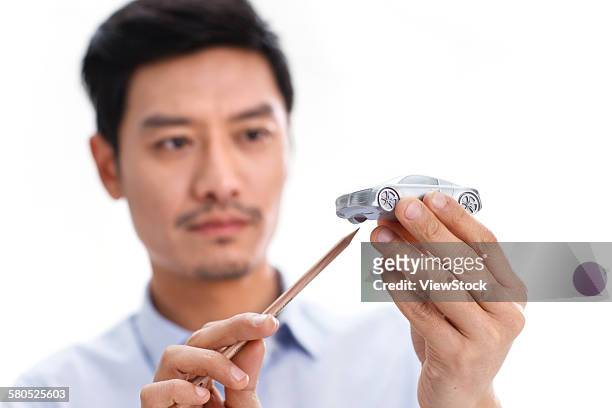 portrait of businessman with model car - auto ontwerper stockfoto's en -beelden