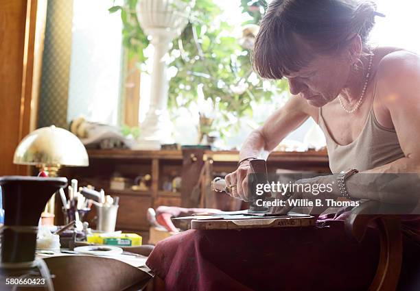 female shoemaker hammering leather - leather vest stock pictures, royalty-free photos & images