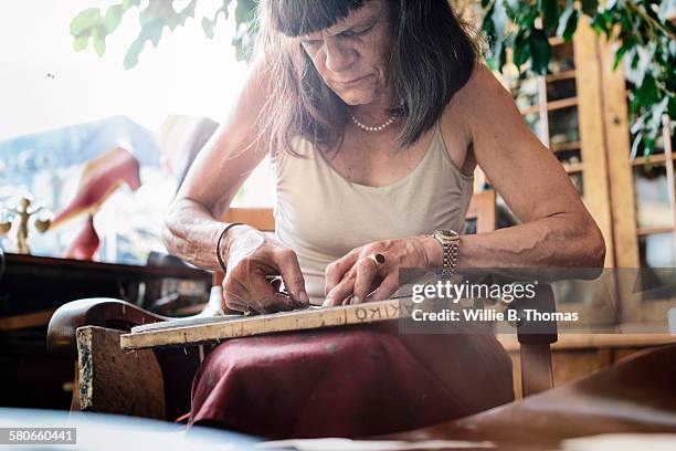 female shoemaker gluing leather together - b fotos - fotografias e filmes do acervo