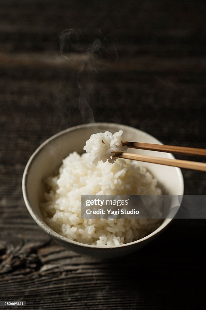 Steamed Rice Served In Bowl on wood
