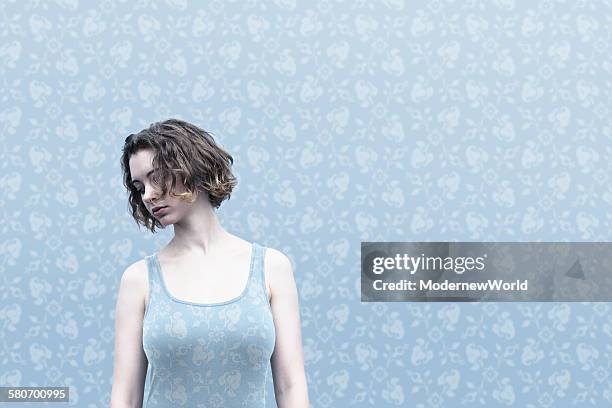 a female dressed same pattern with wall paper 02 - same person different outfits stock-fotos und bilder