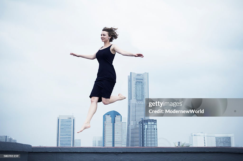 A female jumping in the city scape