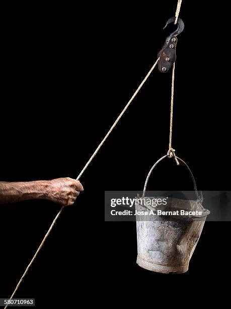 hand of a man pulling strongly a rope - pulley stock pictures, royalty-free photos & images
