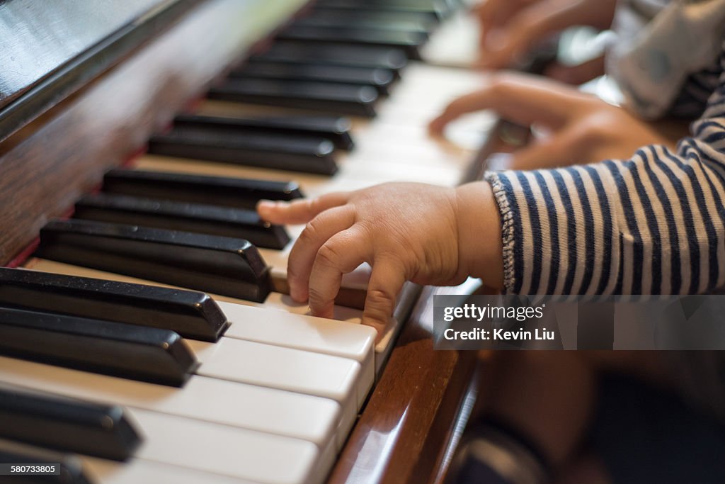 Baby's hand on a piano