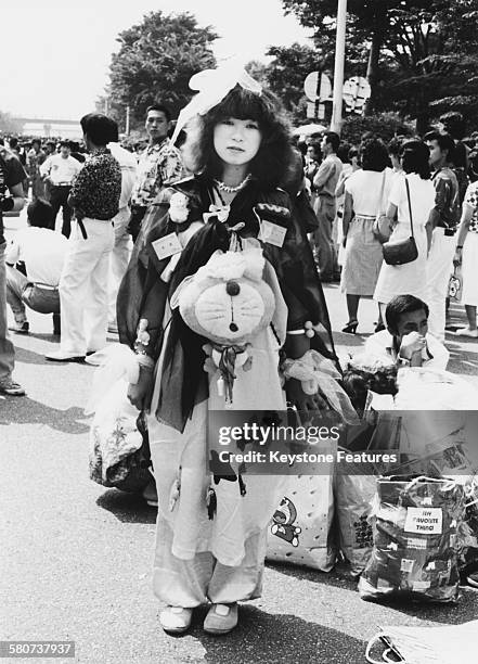 Takenoko-zoku dancers gather in Shibuya, Tokyo, Japan, dressed in distinctive colourful baggy clothing, 15th August 1980. Takenoko-zoku means 'bamboo...