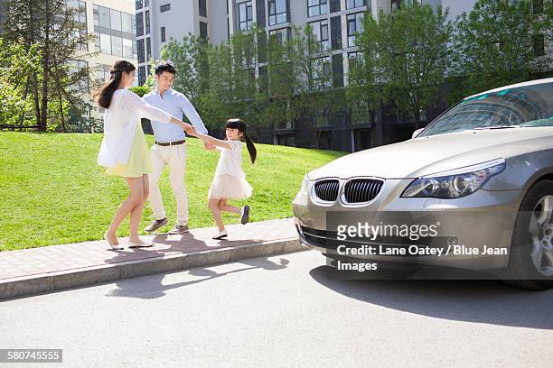 happy young family playing ring-around-the-rosy outdoors - ring around the rosy stock pictures, royalty-free photos & images