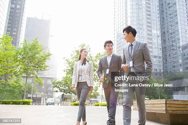 young business person talking outdoors - bussines group suit tie stock-fotos und bilder