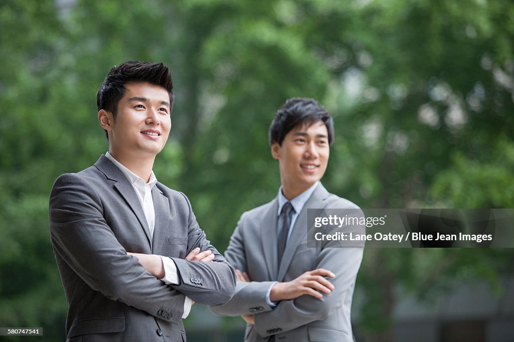 Young businessmen looking at view