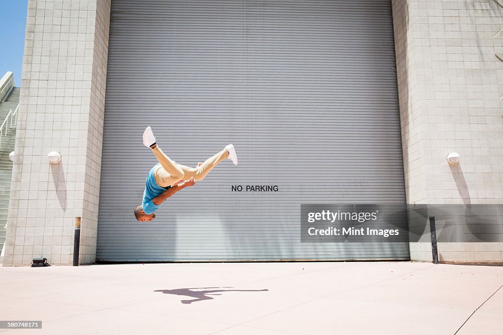 Young man somersaulting, a parcour runner,