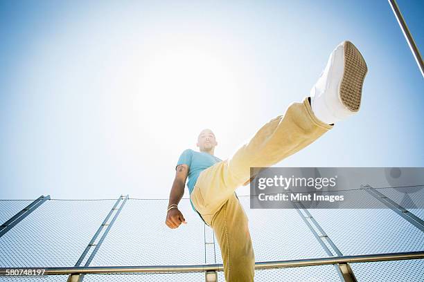 young man somersaulting on a bridge. - back flip bridge stock pictures, royalty-free photos & images