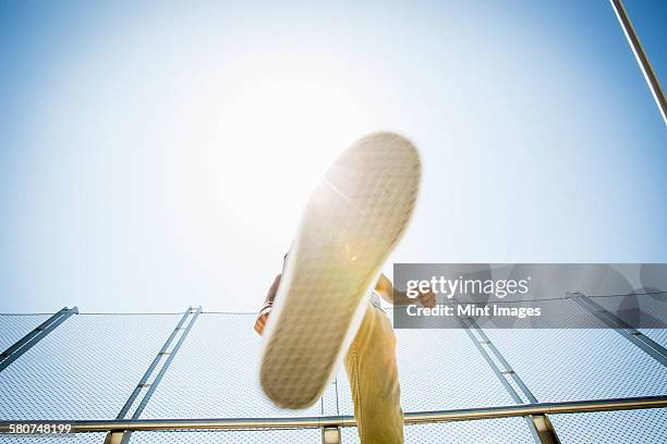 young man somersaulting on a bridge. - back flip bridge stock pictures, royalty-free photos & images