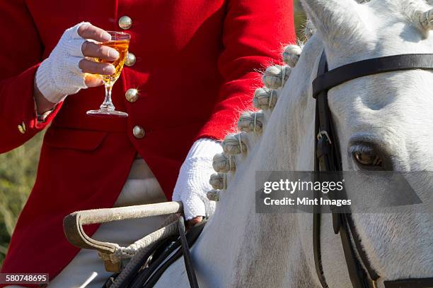 a master of foxhounds having a drink at a hunt meet. - red coat stock pictures, royalty-free photos & images