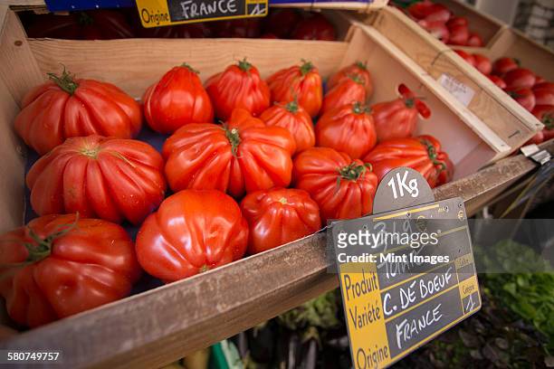 large heirloom tomatoes at a market stall in bonifacio on corsica. - bonifacio stock pictures, royalty-free photos & images