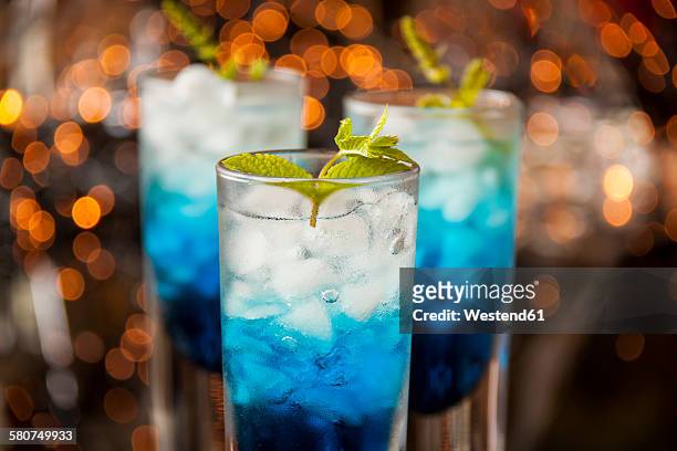 fresh cocktail with blue curacao liquer - blue curacao stock pictures, royalty-free photos & images