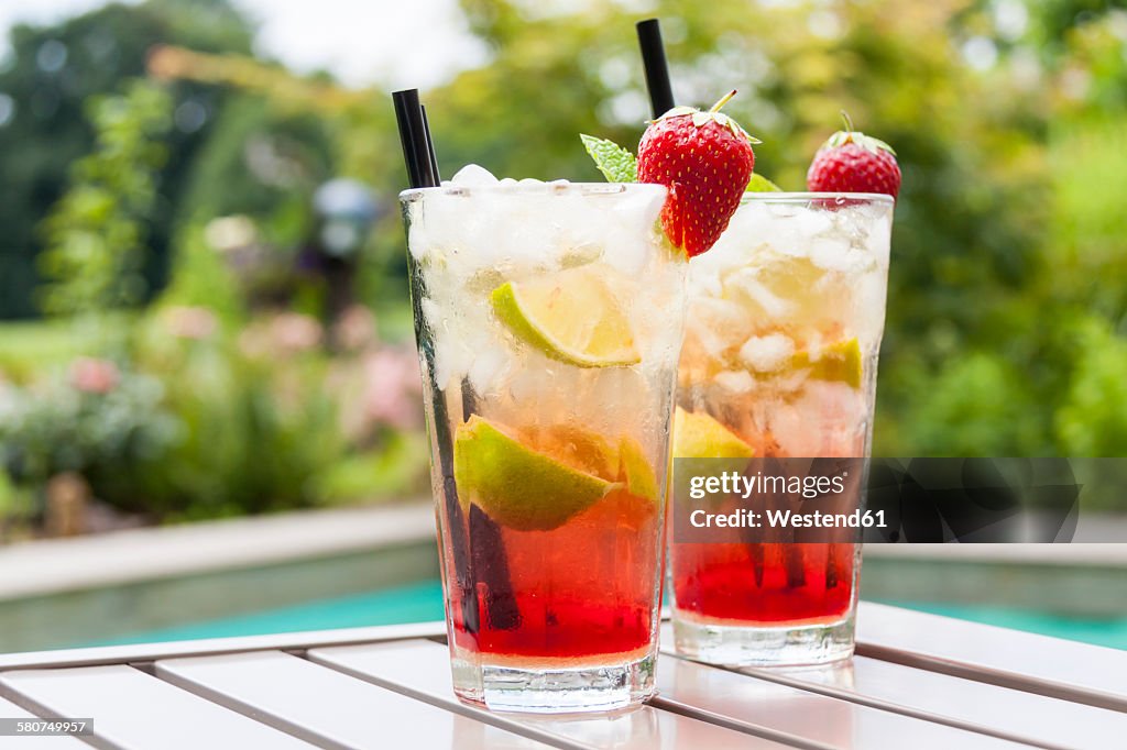 Strawberry Caipirinha with fresh mint and strawberry in glasses