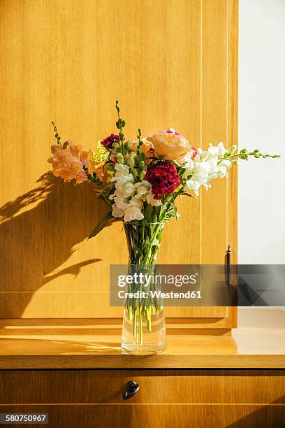 small bouquet of summer flowers on wooden highboard - anrichte stock-fotos und bilder