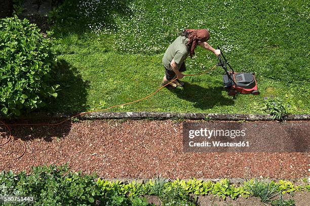 man mowing the lawn - lawnmowing stock pictures, royalty-free photos & images