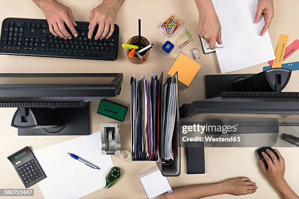 three people working on desk - paperclip imagens e fotografias de stock