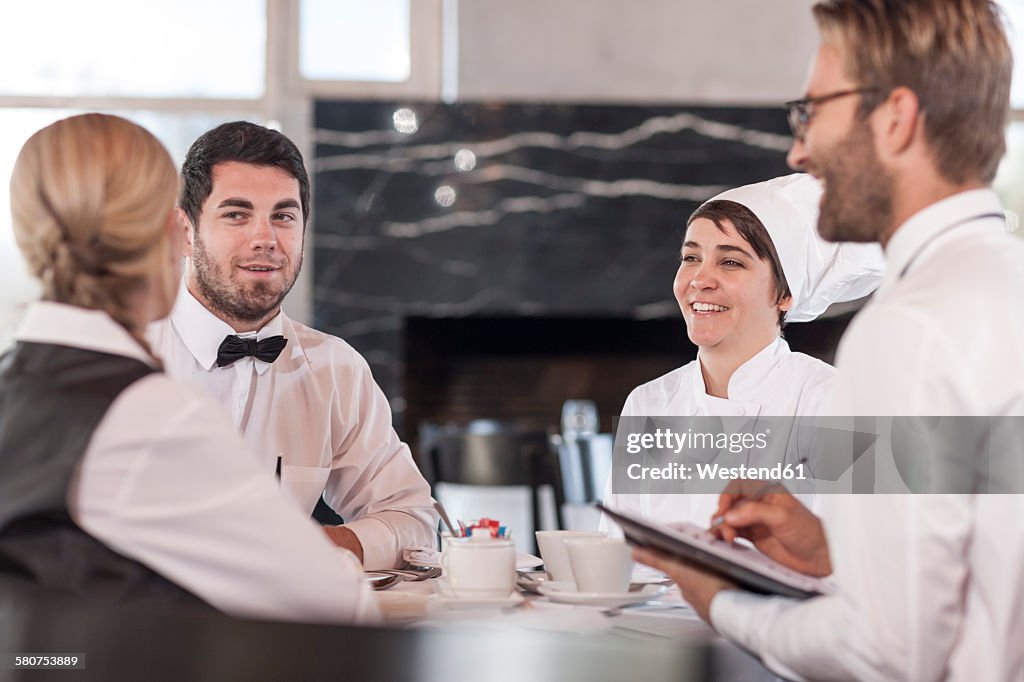 Discussing Menu Options Restaurant Team Discussing Menue And Reservations High-Res Stock Photo ...