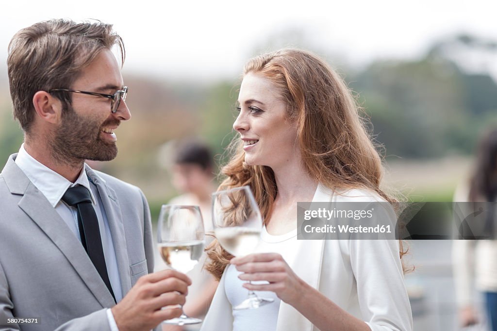 Couple toasting on terrace of a restaurant
