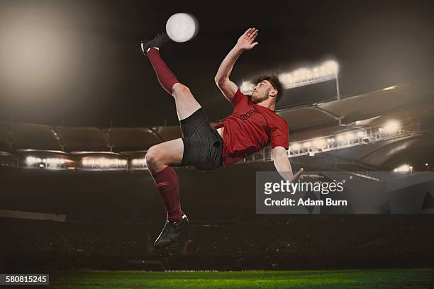full length of soccer player kicking ball on field - rematar à baliza imagens e fotografias de stock
