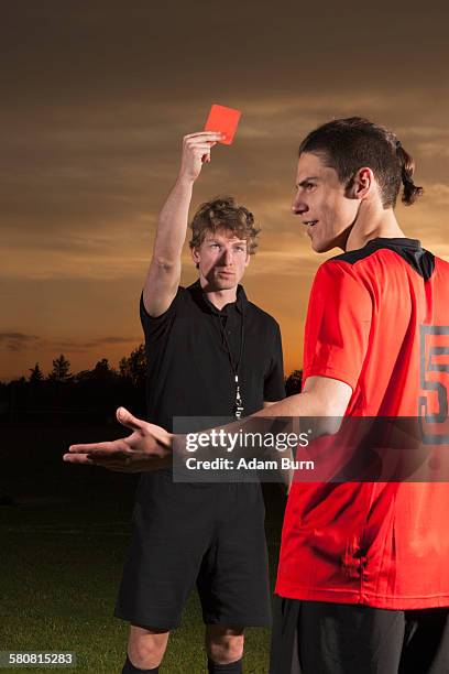 referee showing red card to soccer player - soccer red card stock pictures, royalty-free photos & images