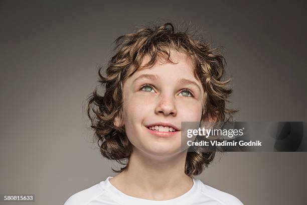 close-up of thoughtful boy over gray background - child looking up stock pictures, royalty-free photos & images