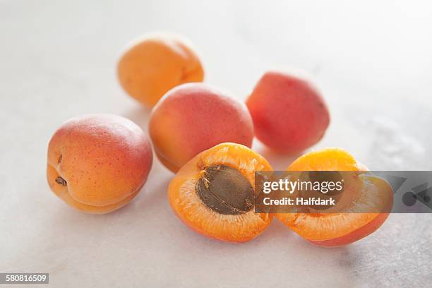 close-up of peaches on white background - pfirsichkern stock-fotos und bilder