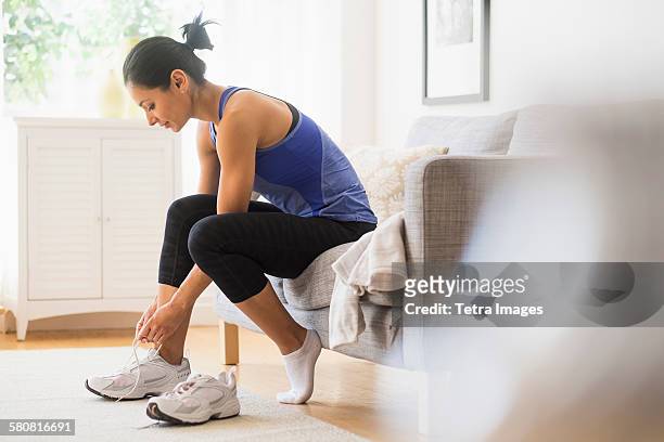 usa, new jersey, young woman putting on shoes - tied up stock pictures, royalty-free photos & images