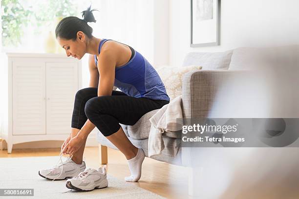 usa, new jersey, young woman putting on shoes - tie stock pictures, royalty-free photos & images