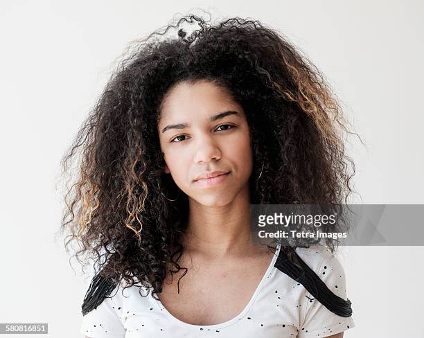 Portrait of teenage girl (16-17) on white background