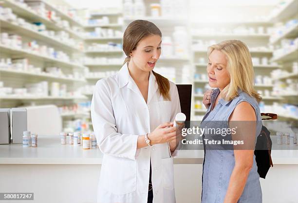 usa, new jersey, patient talking to pharmacist in pharmacy - pharmacist and patient stock pictures, royalty-free photos & images